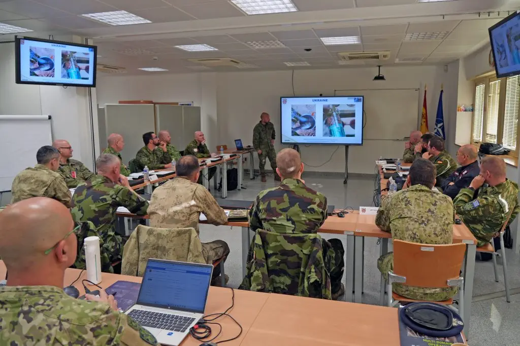 Group of uniformed military personnel seated in a classroom of the C-IED COE attending the course